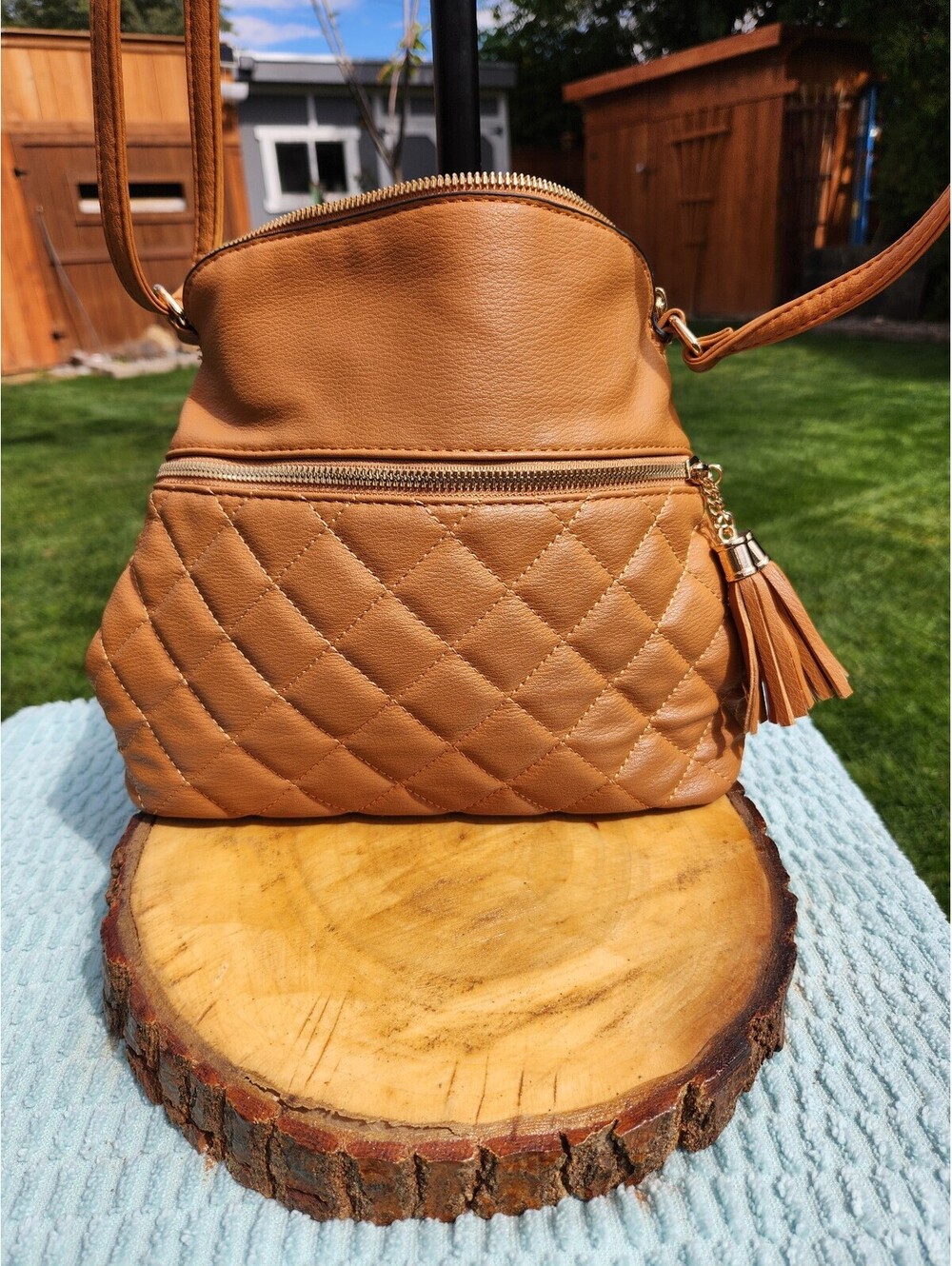 Tan purse with a crossbody strap